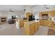 Open kitchen featuring an island, granite countertops, wood cabinets, and stainless steel appliances at 6781 Alpine Brooks Ave, Las Vegas, NV 89130