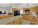 Featuring an island, granite countertops, stainless steel appliances, and wood cabinets at 6781 Alpine Brooks Ave, Las Vegas, NV 89130