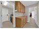 Spacious laundry room with built-in storage cabinets, a utility sink, and a washer and dryer at 6781 Alpine Brooks Ave, Las Vegas, NV 89130