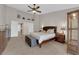 Spacious main bedroom with tiled floors, ceiling fan, and decorative display shelving at 6781 Alpine Brooks Ave, Las Vegas, NV 89130