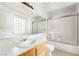 Bright bathroom featuring a large mirror and a shower over the tub at 6857 Tamarus St # 202, Las Vegas, NV 89119