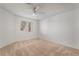 Well-lit bedroom featuring a ceiling fan and a carpeted floor at 6857 Tamarus St # 202, Las Vegas, NV 89119