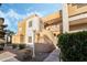 Multi-level condo building featuring a unique architecture with desert landscaping at 6857 Tamarus St # 202, Las Vegas, NV 89119
