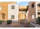 This apartment complex features a curved wall, stucco siding, and desert landscaping at 6857 Tamarus St # 202, Las Vegas, NV 89119