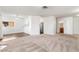 Spacious living room features carpeted flooring and leads into the kitchen and bathroom at 6857 Tamarus St # 202, Las Vegas, NV 89119