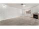Living room with a fireplace, neutral carpet and lots of natural light at 6857 Tamarus St # 202, Las Vegas, NV 89119