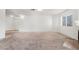 Spacious living room with carpet flooring, fireplace, and neutral paint at 6857 Tamarus St # 202, Las Vegas, NV 89119