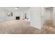 Bright living room with fireplace, carpet, and view to exterior patio at 6857 Tamarus St # 202, Las Vegas, NV 89119