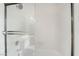 Bright bathroom shower with glass doors and white tile at 6857 Tamarus St # 202, Las Vegas, NV 89119