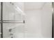Bright bathroom shower with glass doors and white tile at 6857 Tamarus St # 202, Las Vegas, NV 89119