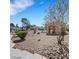 Image of the community space with benches, landscaping, and walking trails on a clear day at 698 S Racetrack Rd # 412, Henderson, NV 89015