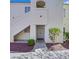 Two-story condo with stucco finish and a landscaped entry with well maintained green space at 698 S Racetrack Rd # 412, Henderson, NV 89015
