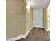Hallway leading to a room with white walls and dark hardwood floors at 698 S Racetrack Rd # 412, Henderson, NV 89015