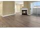 Open living room with hardwood floors, a fireplace, and sliding glass doors to outdoor space at 698 S Racetrack Rd # 412, Henderson, NV 89015