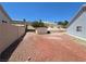 Backyard with desert landscaping, block wall fencing, and a wooden storage shed at 7417 Red Eagle St, Las Vegas, NV 89131