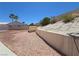 A backyard featuring a desert landscape, block wall fencing, and a storage shed at 7417 Red Eagle St, Las Vegas, NV 89131