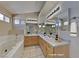 Spacious bathroom with dual sinks, a large mirror, and a separate soaking tub at 7417 Red Eagle St, Las Vegas, NV 89131