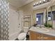 Cozy bathroom featuring a shower-tub combo and modern vanity with a neutral color palette at 7417 Red Eagle St, Las Vegas, NV 89131