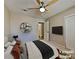 Cozy bedroom with a ceiling fan, closet, and a mounted TV, perfect for relaxation at 7417 Red Eagle St, Las Vegas, NV 89131
