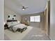 Bright bedroom with vaulted ceiling, soft carpet, and a decorative wall mirror at 7417 Red Eagle St, Las Vegas, NV 89131