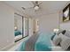Comfortable bedroom with a mirrored closet, soft blue accents, and plenty of natural light at 7417 Red Eagle St, Las Vegas, NV 89131