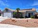 Charming single-story home featuring desert landscaping, a tile roof, and solar panels on a sunny day at 7417 Red Eagle St, Las Vegas, NV 89131