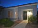 Charming home exterior featuring a secure front door, manicured landscaping, and warm exterior lighting at 7417 Red Eagle St, Las Vegas, NV 89131