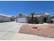View of a single-Gathering home with desert landscaping, a two-car garage, and a paved driveway at 7417 Red Eagle St, Las Vegas, NV 89131