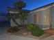 Well-maintained front yard with desert landscaping and a mature palm tree providing curb appeal at 7417 Red Eagle St, Las Vegas, NV 89131