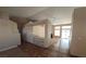 Bright living room featuring tile flooring, a ceiling fan, and a decorative partition with built in shelving at 7417 Red Eagle St, Las Vegas, NV 89131