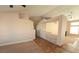 Open-concept living room featuring built-in shelves and tile-carpet flooring at 7417 Red Eagle St, Las Vegas, NV 89131
