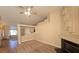 Carpeted living area with a modern fireplace, ceiling fan and an open floor plan at 7417 Red Eagle St, Las Vegas, NV 89131