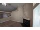 Open living room with carpeted flooring, a decorative fireplace, and large decorative wall accents at 7417 Red Eagle St, Las Vegas, NV 89131