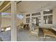 Relaxing covered patio with ceiling fans, dining table and comfortable seating area at 7417 Red Eagle St, Las Vegas, NV 89131