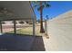 Covered patio area with ceiling fan, overlooking a tiered backyard with desert landscaping and a block wall at 7417 Red Eagle St, Las Vegas, NV 89131