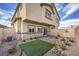 Spacious backyard with a stone patio, partial synthetic grass and minimal plants at 7915 Pandora Sky St # 402, Las Vegas, NV 89084