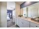 Modern bathroom featuring white cabinets, a large mirror, and calming light for a relaxing ambiance at 7915 Pandora Sky St # 402, Las Vegas, NV 89084