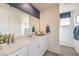 Bright bathroom showcasing a large mirror, white cabinetry, and modern fixtures at 7915 Pandora Sky St # 402, Las Vegas, NV 89084