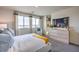 Bright bedroom showcasing large windows, plush carpet, and a comfortable seating area for relaxation at 7915 Pandora Sky St # 402, Las Vegas, NV 89084