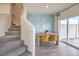 Bright dining area with modern table and chairs, adjacent to a sliding glass door and stairs at 7915 Pandora Sky St # 402, Las Vegas, NV 89084