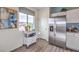 Modern kitchen area with stainless steel fridge, white cabinets, and bright natural light at 7915 Pandora Sky St # 402, Las Vegas, NV 89084