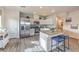 Bright, modern kitchen with stainless steel appliances and a central island with seating at 7915 Pandora Sky St # 402, Las Vegas, NV 89084
