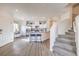 Open-concept living space with kitchen, dining, and staircase in a modern design at 7915 Pandora Sky St # 402, Las Vegas, NV 89084