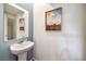 Elegant powder room featuring a pedestal sink and stylish wall decor at 7915 Pandora Sky St # 402, Las Vegas, NV 89084