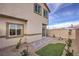 Gravel backyard with patio, partial turf area, and mountain views, offering a simple and private outdoor space at 7915 Pandora Sky St # 403, North Las Vegas, NV 89084