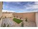 Spacious backyard with gravel landscaping, partial turf area, and brick-paved patio for low-maintenance living at 7915 Pandora Sky St # 403, North Las Vegas, NV 89084