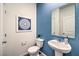 Stylish powder room with modern fixtures, blue accent wall and decor at 7915 Pandora Sky St # 403, North Las Vegas, NV 89084