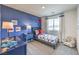 Fun, airplane-themed bedroom with bright blue walls, a large window, and plush carpet at 7915 Pandora Sky St # 403, North Las Vegas, NV 89084