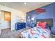 Airplane-themed bedroom with blue accent wall, plush carpet, and modern furnishings at 7915 Pandora Sky St # 403, North Las Vegas, NV 89084