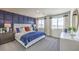 Spacious bedroom features a board and batten accent wall, plush carpet, and large windows with great natural light at 7915 Pandora Sky St # 403, North Las Vegas, NV 89084
